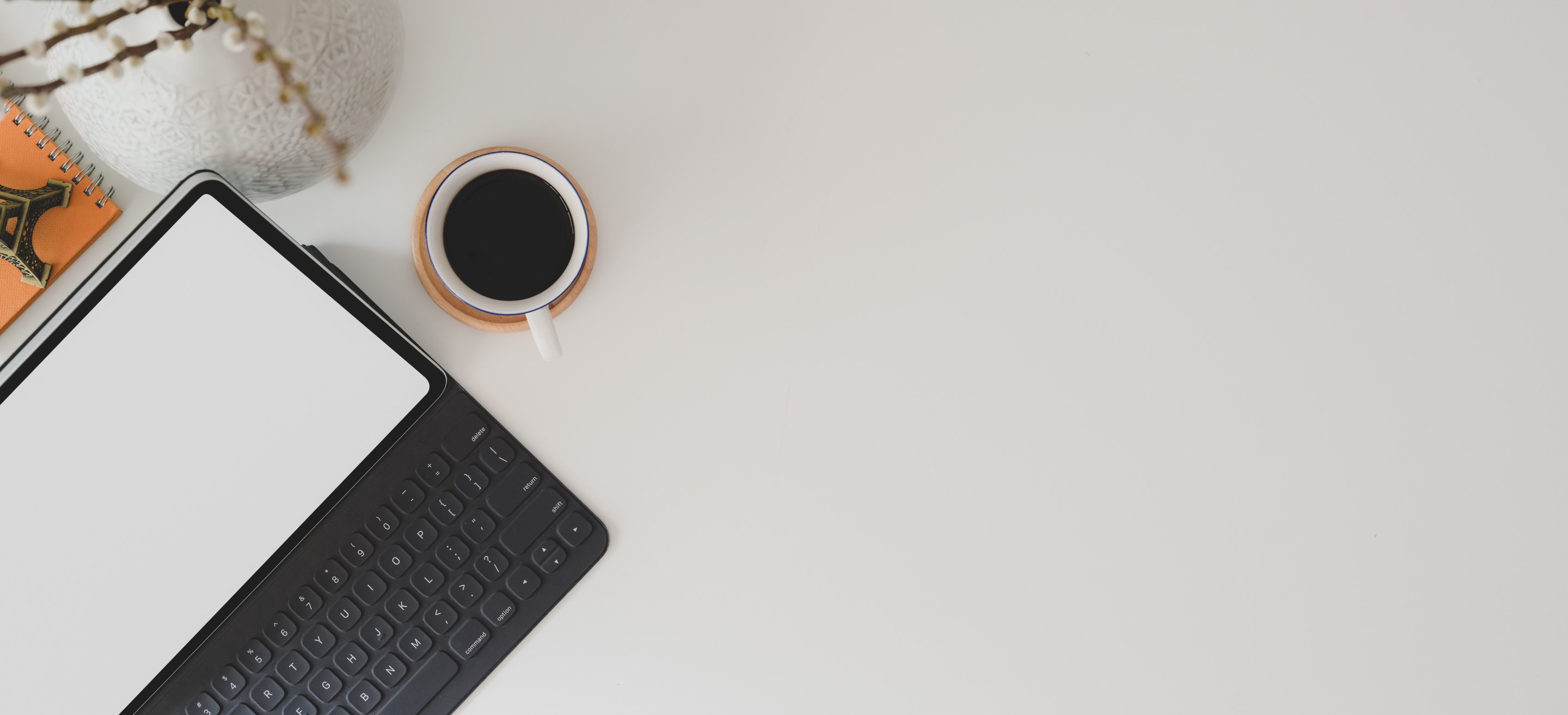 White Ceramic Mug on White Table Near Laptop